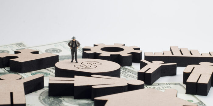 figure with a man on wood background, finance concept